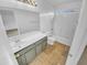 Clean bathroom with gray vanity, toilet, and bathtub at 12517 W Rosewood Dr, El Mirage, AZ 85335