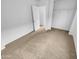 Bright bedroom featuring neutral carpeting and ample closet space at 12517 W Rosewood Dr, El Mirage, AZ 85335