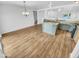 Bright kitchen features an island and light wood flooring at 12517 W Rosewood Dr, El Mirage, AZ 85335