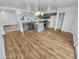 Modern kitchen with gray cabinets, island, and light wood flooring at 12517 W Rosewood Dr, El Mirage, AZ 85335