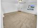 Spacious living room with neutral colored carpet and lots of natural light at 12517 W Rosewood Dr, El Mirage, AZ 85335