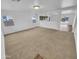 Open living room with a view into the kitchen and access to the backyard at 12517 W Rosewood Dr, El Mirage, AZ 85335