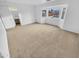Spacious main bedroom with neutral carpet and large window overlooking pool at 12517 W Rosewood Dr, El Mirage, AZ 85335