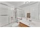 Updated bathroom with tub/shower combo and wood vanity at 13638 W Desert Flower Dr, Goodyear, AZ 85395