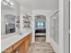 Main bathroom with large vanity, walk-in shower, and bedroom view at 13638 W Desert Flower Dr, Goodyear, AZ 85395