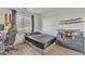 Well-lit bedroom, featuring a bed, dresser, and workspace at 13638 W Desert Flower Dr, Goodyear, AZ 85395