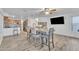 Open dining area with kitchen view, gray table, and chairs at 13638 W Desert Flower Dr, Goodyear, AZ 85395