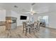 Dining area with a large table, chairs, and wood-look flooring at 13638 W Desert Flower Dr, Goodyear, AZ 85395