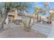 Two-story house with tan exterior, two-car garage, and palm trees at 13638 W Desert Flower Dr, Goodyear, AZ 85395