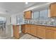 Kitchen with granite counters and wood cabinets at 13638 W Desert Flower Dr, Goodyear, AZ 85395