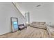 Living area featuring light wood floors and a large mirror at 13638 W Desert Flower Dr, Goodyear, AZ 85395