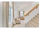 Bright living room with light flooring, staircase, and beige sofa at 13638 W Desert Flower Dr, Goodyear, AZ 85395