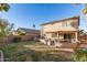 Large backyard with patio, grassy area, and a hammock at 13829 W Rovey Ave, Litchfield Park, AZ 85340