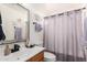 Bathroom with tub shower and light-purple curtains at 13829 W Rovey Ave, Litchfield Park, AZ 85340