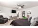 Spacious bedroom with ceiling fan and large TV at 13829 W Rovey Ave, Litchfield Park, AZ 85340