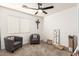 Small bedroom with two armchairs and window blinds at 13829 W Rovey Ave, Litchfield Park, AZ 85340