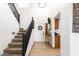 Bright entryway with staircase, console table, and decorative wall art at 13829 W Rovey Ave, Litchfield Park, AZ 85340