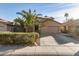 Two-story house with solar panels, palm trees, and a two-car garage at 13829 W Rovey Ave, Litchfield Park, AZ 85340