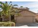 Two-story house with solar panels, landscaped yard, and a two-car garage at 13829 W Rovey Ave, Litchfield Park, AZ 85340