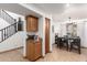 Kitchen features a staircase and wood cabinetry at 13829 W Rovey Ave, Litchfield Park, AZ 85340