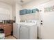 Laundry room with washer, dryer and shelving at 13829 W Rovey Ave, Litchfield Park, AZ 85340