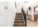 Staircase with dark wood railing leading to the second floor at 13829 W Rovey Ave, Litchfield Park, AZ 85340