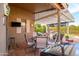 A covered patio offers a great outdoor living space with a dining and seating area with views of the backyard at 17202 N Javelina Dr, Surprise, AZ 85374
