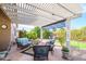 Inviting covered patio with comfortable seating and lush landscaping offers a relaxing outdoor retreat at 17202 N Javelina Dr, Surprise, AZ 85374