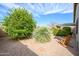 Landscaped backyard features rock ground cover and various bushes and plants that provide great privacy at 17202 N Javelina Dr, Surprise, AZ 85374