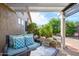 Covered outdoor patio features comfortable seating and a view into the beautiful and tranquil backyard at 17202 N Javelina Dr, Surprise, AZ 85374