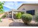A backyard features rock ground cover, various plants and bushes and a covered outdoor living space at 17202 N Javelina Dr, Surprise, AZ 85374