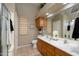 Well-lit bathroom featuring double sinks, oak cabinets, and a spacious walk-in shower at 17202 N Javelina Dr, Surprise, AZ 85374