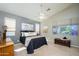 Bright bedroom with large windows, neutral tones, and ceiling fan for comfort at 17202 N Javelina Dr, Surprise, AZ 85374