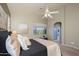Cozy bedroom with plush bedding, a window view, and ensuite bathroom at 17202 N Javelina Dr, Surprise, AZ 85374