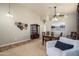 Inviting dining room with a wooden table, display cabinet, and a comfortable armchair at 17202 N Javelina Dr, Surprise, AZ 85374