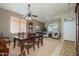 Elegant dining area with a wooden table, chairs, large window, and comfortable seating area at 17202 N Javelina Dr, Surprise, AZ 85374
