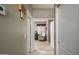 Hallway leading to a cozy sitting area with a comfortable chair and natural light at 17202 N Javelina Dr, Surprise, AZ 85374