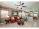 Inviting living room with a red sofa, stylish decor, and an open view to the adjacent kitchen at 17202 N Javelina Dr, Surprise, AZ 85374