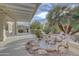 Relaxing backyard oasis with a waterfall feature and covered patio area at 17733 N Escalante Ln, Surprise, AZ 85374