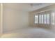 Spacious bedroom featuring a large window and carpet flooring at 17733 N Escalante Ln, Surprise, AZ 85374