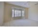 Bright bedroom with bay window and ceiling fan at 17733 N Escalante Ln, Surprise, AZ 85374
