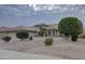 Single-story home with a tile roof, landscaped yard, and a two-car garage at 17733 N Escalante Ln, Surprise, AZ 85374