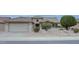 Tan two-car garage home with desert landscaping at 17733 N Escalante Ln, Surprise, AZ 85374