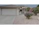 Front view of a house with a two-car garage and nicely landscaped yard at 17733 N Escalante Ln, Surprise, AZ 85374