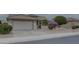 Single-story home with attached garage and well-manicured landscaping at 17733 N Escalante Ln, Surprise, AZ 85374