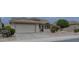 House exterior featuring a two-car garage and desert landscaping at 17733 N Escalante Ln, Surprise, AZ 85374
