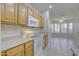 Kitchen features white appliances and light wood cabinets at 17733 N Escalante Ln, Surprise, AZ 85374