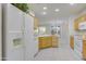 Kitchen with white appliances, light wood cabinets, and an island at 17733 N Escalante Ln, Surprise, AZ 85374