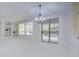 Spacious living area with a chandelier and access to a backyard patio at 17733 N Escalante Ln, Surprise, AZ 85374