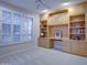 Home office with built-in desk and shelving unit at 17733 N Escalante Ln, Surprise, AZ 85374